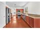 Spacious kitchen with stainless steel appliances, granite counters, and red-brown cabinetry at 1304 Autumn Wind Way, Henderson, NV 89052