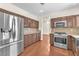 Well-lit kitchen features stainless steel appliances, granite countertops, and hardwood flooring at 1304 Autumn Wind Way, Henderson, NV 89052