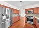 Bright kitchen featuring stainless steel refrigerator, granite countertops and backsplash at 1304 Autumn Wind Way, Henderson, NV 89052