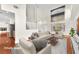 Bright, staged living room with high ceilings, large windows, and hardwood floors at 1304 Autumn Wind Way, Henderson, NV 89052