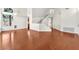 Large living area with hardwood floors, large windows, white walls, and staircase with white banister at 1304 Autumn Wind Way, Henderson, NV 89052
