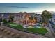Expansive backyard features a pool, lush greenery, and a putting green, providing ample space for recreation at 1377 Ruby Sky Ct, Henderson, NV 89052