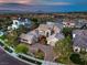 A stunning aerial view showcasing a spacious home, lake, and a meticulously landscaped yard, offering luxury living at 1377 Ruby Sky Ct, Henderson, NV 89052