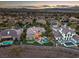 An aerial shot of a luxurious property with a pool, putting green, and well-manicured landscaping, perfect for outdoor living at 1377 Ruby Sky Ct, Henderson, NV 89052