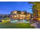 A gorgeous backyard featuring a sparkling pool, tropical palms, and an inviting patio area at 1377 Ruby Sky Ct, Henderson, NV 89052