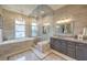 Luxurious bathroom features a soaking tub, walk-in shower, dual sink vanity, and elegant tile work at 1377 Ruby Sky Ct, Henderson, NV 89052