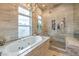 This primary bath features a shower, soaking tub, and a picture window to let in the light at 1377 Ruby Sky Ct, Henderson, NV 89052