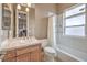 This bathroom features a combo tub/shower, window, a vanity, and a tile floor at 1377 Ruby Sky Ct, Henderson, NV 89052