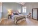Airy bedroom with blue walls, a decorative chandelier, and upholstered headboard with complementary throw pillows at 1377 Ruby Sky Ct, Henderson, NV 89052