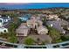 Elegant home boasts a manicured lawn, a circular driveway, and a grand entrance, exuding curb appeal at 1377 Ruby Sky Ct, Henderson, NV 89052