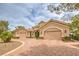 Elegant exterior showcasing a circular driveway and a grand three-car garage, creating an impressive curb appeal at 1377 Ruby Sky Ct, Henderson, NV 89052