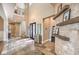 Welcoming foyer features soaring ceilings, stone accents, decorative tile flooring, and a glimpse of the upper level at 1377 Ruby Sky Ct, Henderson, NV 89052