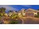 Elegant home boasts a manicured front yard, stone accents, and a brick driveway leading to a three-car garage at 1377 Ruby Sky Ct, Henderson, NV 89052