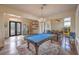 Spacious game room with a pool table, elegant chandelier, and an open layout connecting to the living spaces at 1377 Ruby Sky Ct, Henderson, NV 89052