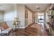 Bright upstairs hallway with hardwood floors, stylish decor, and an open doorway to another room at 1377 Ruby Sky Ct, Henderson, NV 89052