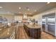 Gourmet kitchen showcases a large island, custom cabinetry, granite countertops, and stainless steel appliances at 1377 Ruby Sky Ct, Henderson, NV 89052