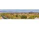 Panoramic view of lush greenery, mature trees, and tile roofs, with mountains in the distance at 1377 Ruby Sky Ct, Henderson, NV 89052
