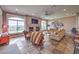 Inviting living room featuring a fireplace, large windows, and stylish decor at 1377 Ruby Sky Ct, Henderson, NV 89052