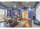 Well-appointed media room with leather couch, movie posters, projector, and hardwood floors at 1377 Ruby Sky Ct, Henderson, NV 89052