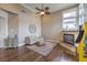 Inviting living room featuring a fireplace, high ceilings, a ceiling fan, and ample natural light at 1377 Ruby Sky Ct, Henderson, NV 89052