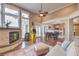 Open-concept living space boasts a fireplace, seamless transitions to the game room and dining area, and large windows at 1377 Ruby Sky Ct, Henderson, NV 89052