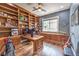 Home office with custom wood built-ins, including shelving and a window seat, plus hardwood floors at 1377 Ruby Sky Ct, Henderson, NV 89052