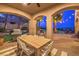 Covered outdoor dining area with a grill, views of the pool and palm trees at 1377 Ruby Sky Ct, Henderson, NV 89052