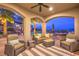 Inviting outdoor living space with comfortable seating, ceiling fan, and views of the pool and yard at 1377 Ruby Sky Ct, Henderson, NV 89052