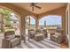 Covered outdoor living area with comfortable seating and views of the pool and landscape at 1377 Ruby Sky Ct, Henderson, NV 89052