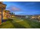 Backyard boasts a putting green, outdoor kitchen and dining area with mountain views at 1377 Ruby Sky Ct, Henderson, NV 89052