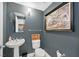 Powder room with a pedestal sink, decorative wall art and modern lighting at 150 Las Vegas Blvd # 1004, Las Vegas, NV 89101