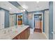 Bathroom featuring double sinks, a large mirror, walk-in closet and walk-in shower at 150 Las Vegas Blvd # 1004, Las Vegas, NV 89101