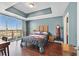 Bedroom with hardwood floors, a balcony with city views, and a unique tray ceiling at 150 Las Vegas Blvd # 1004, Las Vegas, NV 89101