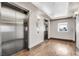 The well-maintained elevator lobby features modern elevators, wooden floors, and a window overlooking the city at 150 Las Vegas Blvd # 1004, Las Vegas, NV 89101