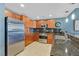 Modern kitchen featuring stainless steel appliances, granite countertops, and warm wood cabinetry at 150 Las Vegas Blvd # 1004, Las Vegas, NV 89101