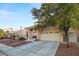 Two-story home with a tile roof, landscaped front yard, and attached two-car garage at 1705 Desert Ridge Ave, North Las Vegas, NV 89031