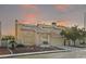 Inviting two-story home with a tile roof, landscaped front yard, and attached two-car garage at 1705 Desert Ridge Ave, North Las Vegas, NV 89031