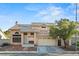 Charming two-story home with a tile roof, well-kept front yard, and attached two-car garage at 1705 Desert Ridge Ave, North Las Vegas, NV 89031