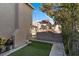 A cozy backyard with a small artificial turf area and brick features at 1708 Crest Ave, Las Vegas, NV 89119