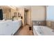 Bright bathroom with double vanity, soaking tub, and neutral tile accents at 1708 Crest Ave, Las Vegas, NV 89119