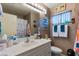 Functional bathroom with single sink vanity and shower-tub combination at 1708 Crest Ave, Las Vegas, NV 89119