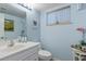 Cozy bathroom with a white vanity, a toilet, and a window letting in natural light at 1708 Crest Ave, Las Vegas, NV 89119