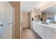 Bathroom featuring a glass-door shower and vanity with double sinks at 1708 Crest Ave, Las Vegas, NV 89119