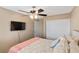 This bedroom has a ceiling fan, and TV, with a comfy floral bedspread at 1708 Crest Ave, Las Vegas, NV 89119