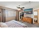 Well-lit bedroom with ceiling fan, TV, and closet; neutral color palette at 1708 Crest Ave, Las Vegas, NV 89119