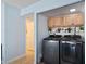 Modern laundry room with stainless steel washer and dryer plus upper cabinets for storage at 1708 Crest Ave, Las Vegas, NV 89119