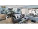 Cozy living area with tile flooring, a comfortable sofa, and a view of the lush backyard and pool area at 1708 Crest Ave, Las Vegas, NV 89119