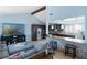 Stylish living room with a partial view of the modern kitchen, breakfast bar, and comfortable seating area at 1708 Crest Ave, Las Vegas, NV 89119