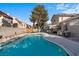 The backyard boasts a pristine pool, ideal for relaxation and recreation, surrounded by ample patio space and mature trees at 1708 Crest Ave, Las Vegas, NV 89119