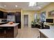 Bright kitchen with stainless steel appliances, dark cabinetry, and light tile flooring at 1908 Oliver Springs St, Henderson, NV 89052